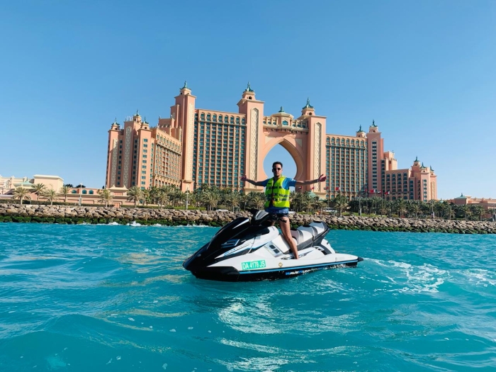 group of friends on their jet ski in front of the Burj Al Arab